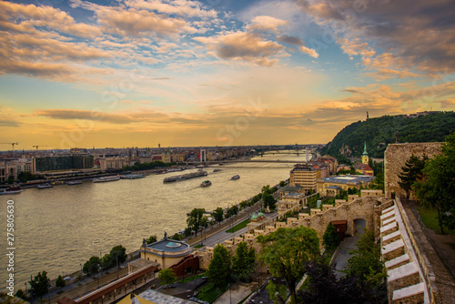 Budapest, Hungary: Beautiful landscape with bridge on the Danube river and old buildings of the old town at sunset photo