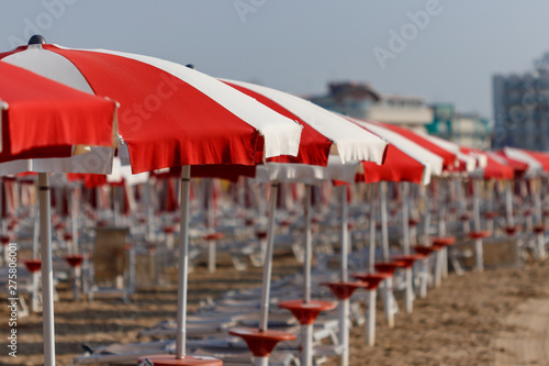 Fototapeta Naklejka Na Ścianę i Meble -  row of white and red umbrellas at the beach 
