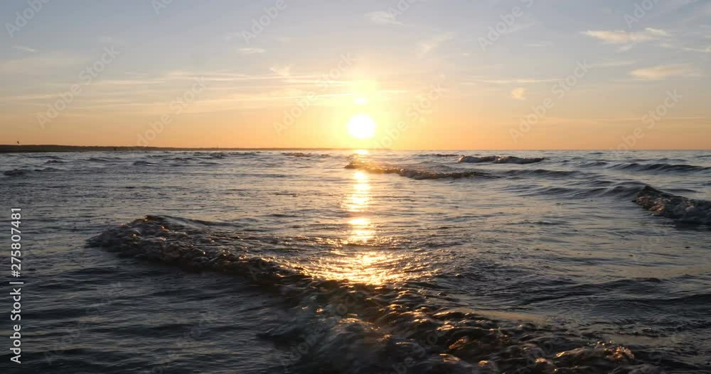 Beautiful fiery sunset sky on the beach. Composition of nature, Waves of the sea on a sandy beach. Beautiful fiery sunset sky on the beach. Composition of nature, Waves of the sea on a sandy beach.