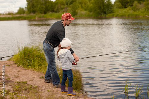 Dad and daughter fishing on lake