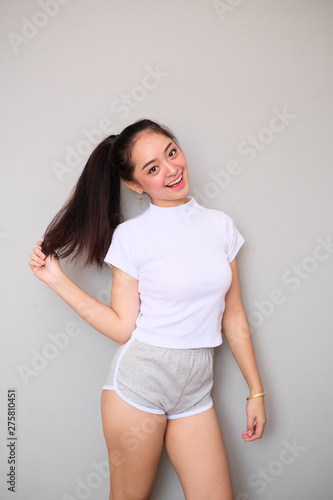 Asian girl in sportswear with happy expression.