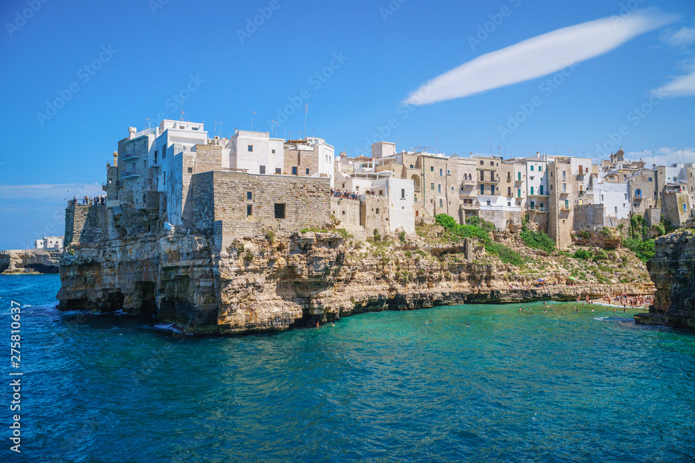 View of sea from Polignano a Mare and beach with tourists, Puglia, Italy