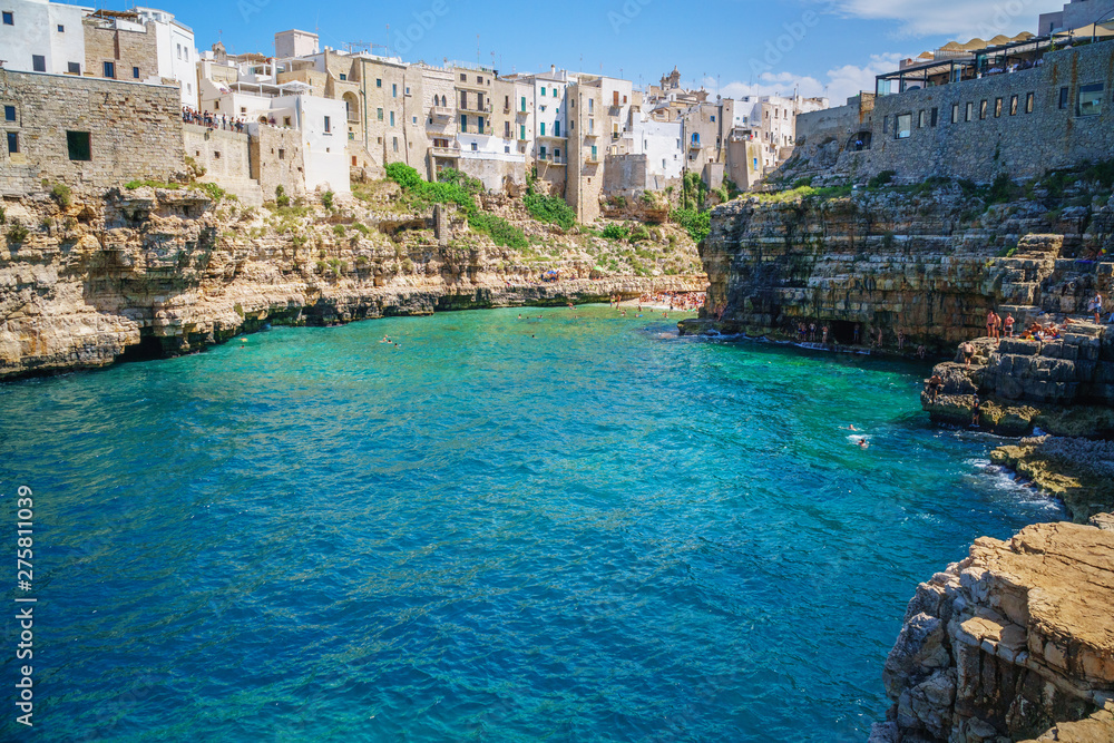 View of sea from Polignano a Mare and beach with tourists, Puglia, Italy