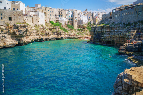 Fototapeta Naklejka Na Ścianę i Meble -  View of sea from Polignano a Mare and beach with tourists, Puglia, Italy