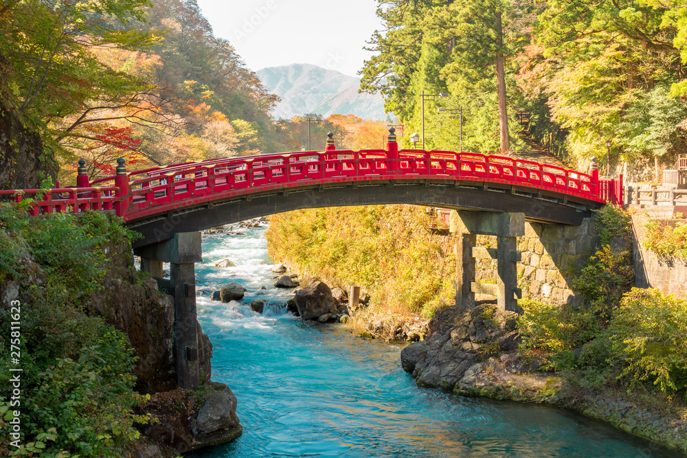 Shinkyo red bridge, landmark of Nikko the world heritage site of Japan. Wonderful scenic view with warm sun shade and turquoise blue water. Shinkyo red bridge, landmark of Nikko the world heritage site of Japan. Wonderful scenic view with warm sun shade and turquoise blue water.