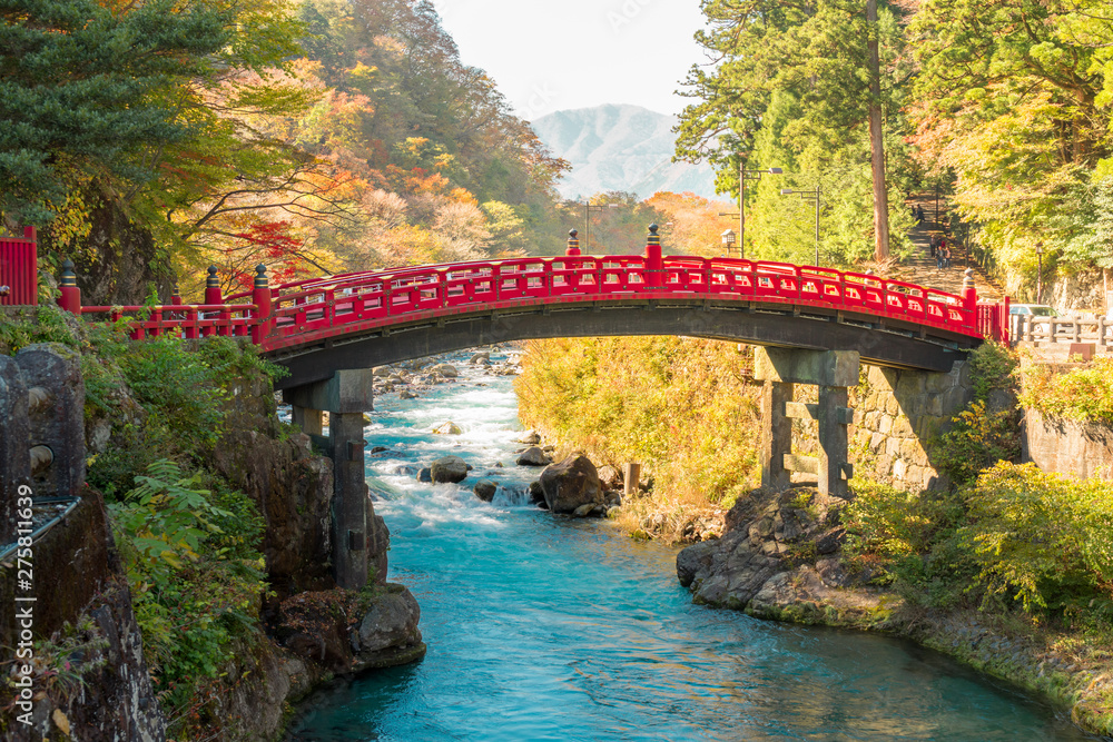 Shinkyo red bridge, landmark of Nikko the world heritage site of Japan. Wonderful scenic view with warm sun shade and turquoise blue water. Shinkyo red bridge, landmark of Nikko the world heritage site of Japan. Wonderful scenic view with warm sun shade and turquoise blue water.