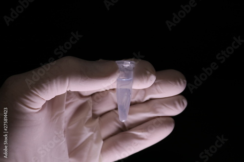 White gloved hand with test tube