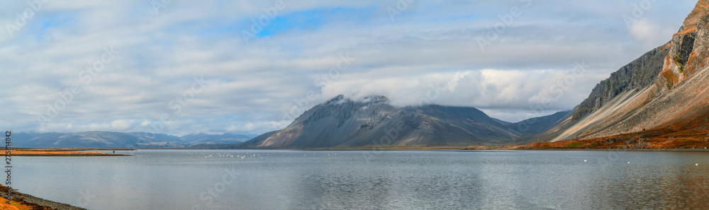 Sea coast with mountain reflection, Iceland