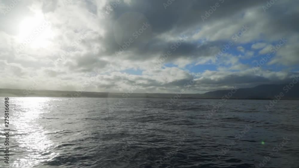 Slow Motion: Sun Reflecting Off Of Gray Ocean Waves, Cloudy Blue Sky, Kauai, Hawaii Slow Motion: Sun Reflecting Off Of Gray Ocean Waves, Cloudy Blue Sky, Kauai, Hawaii