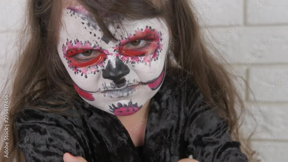 Angry child for Halloween. Little girl in scary makeup. Halloween child. Angry child for Halloween. Little girl in scary makeup. Halloween child.