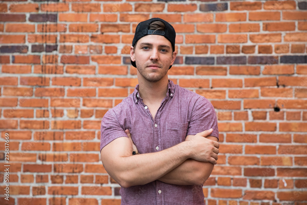 Handsome Young Caucasian Man with Backwards Hat Smiling for Portraits