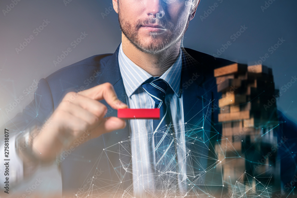 © whyframeshot - business man try to build wood block on wooden table and black background business organization startup concept