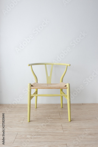 Minimalist architect designer concept with green classic chair on wooden floor with white wall background.