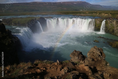 Dramatic waterfall with rainbow in Iceland