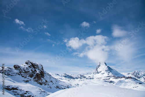 The famous mountain Matterhorn peak with cloudy and blue sky from Gornergrat, Zermatt, Switzerland © canjoena