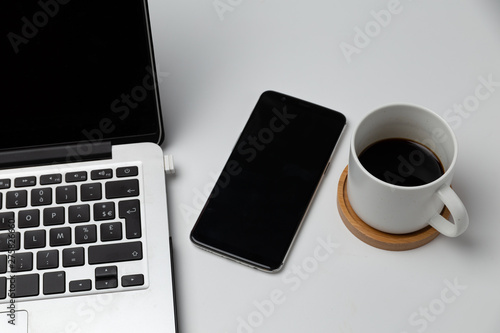 close up of smartphone and coffee cup . business and workplace concept . isolated freelancer tools