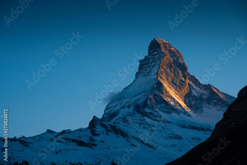 Closeup the famous Matterhorn peak snow mountain landscape in sunset at Gornergrat station in Zermatt, Switzerland © canjoena