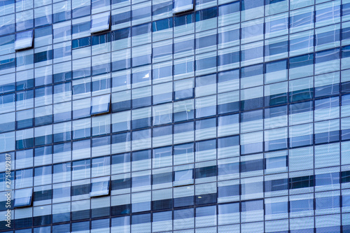 Glass blue square Windows of facade modern city business building skyscraper. Modern apartment buildings in new neighborhood. Windows of a building  texture.