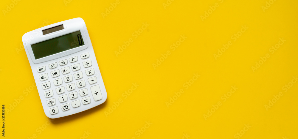 close up white calculator on yellow background for business financial concept close up white calculator on yellow background for business financial concept