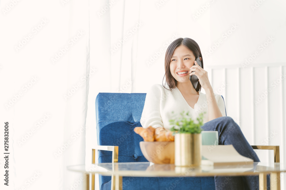 Young Asian woman using phone talking happy and smile.