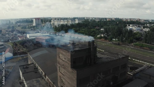 Industrial zone with smoke is poured from the factory pipe. Pollution of the environment: a pipe with smoke. Aerial view