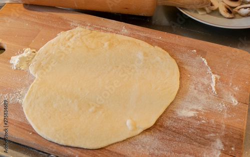 Pizzza bread laying on a wooden table