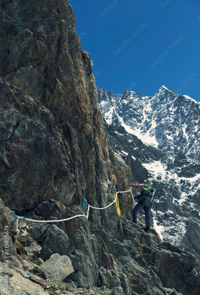 Obraz premium Hiker traveling in Alps. Alpine peaks landskape background. Jungfrau, Bernese highland. Sport, tourism and hiking concept.