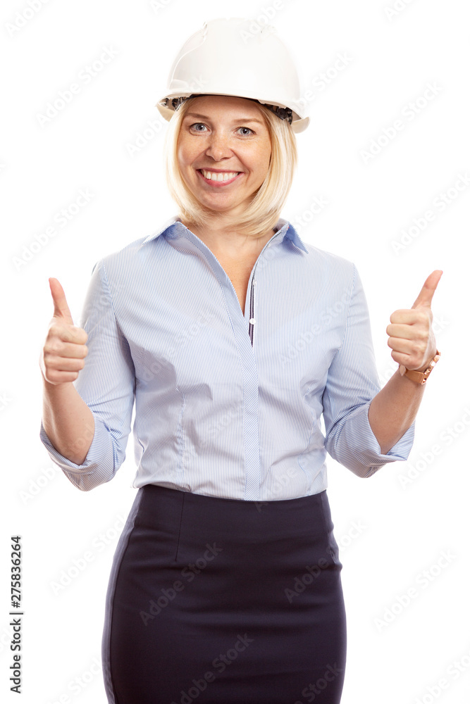 Smiling young woman in office clothes and a construction helmet on her head. Thumbs up. Vertical. White background. Smiling young woman in office clothes and a construction helmet on her head. Thumbs up. Vertical. White background.