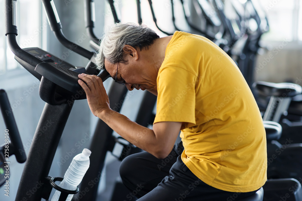 Old man suffer from heart attack in gym Old man suffer from heart attack in gym