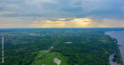 drone hyperlapse: spectacular and very colorful sunset over the golf course in the private residence of Mezhyhiria and the small village of New Petrovtsy .Kyiv, Ukraine  - Cityscape Aerial Flight photo