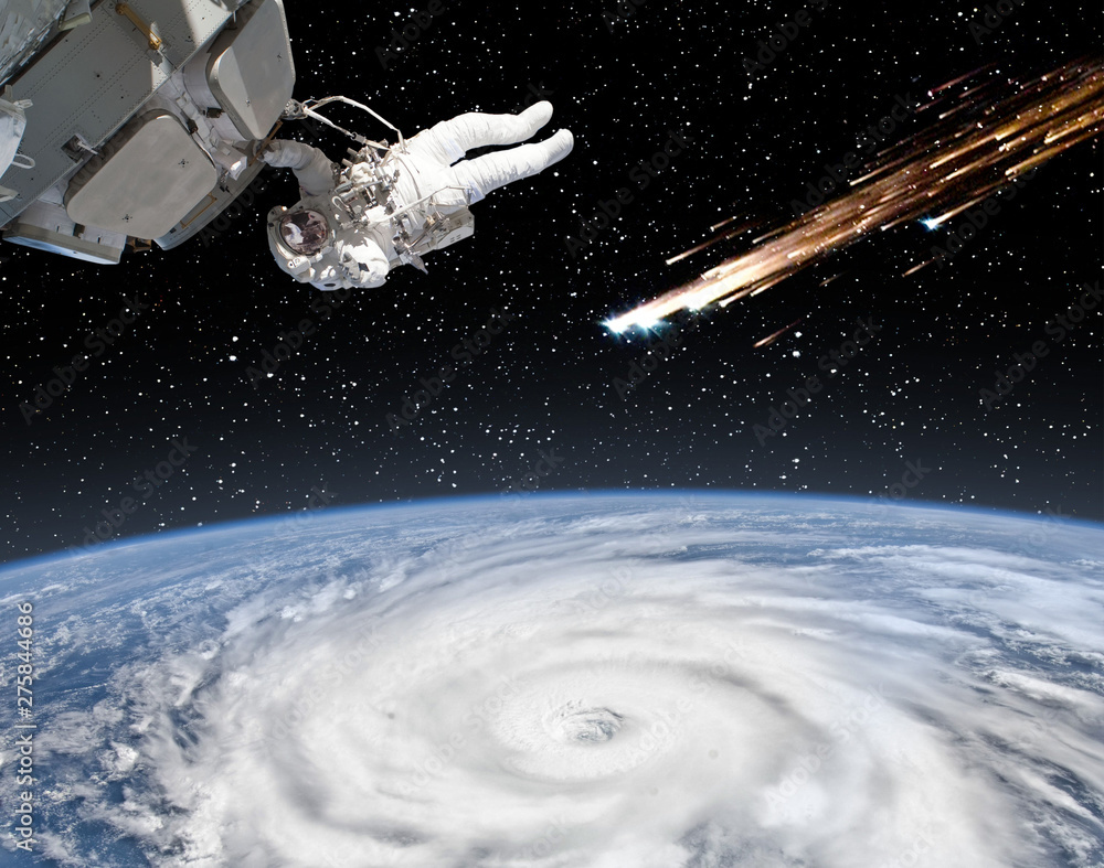 Astronaut holding for the spaceship and meteor rain. The elements of this image furnished by NASA. Astronaut holding for the spaceship and meteor rain. The elements of this image furnished by NASA.