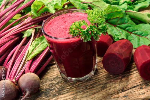 Healthy eating concept - fresh beet juice with parsley from organic farm in a glass on a wooden rustic table.