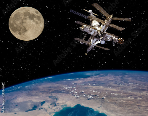 Moon and space station flying near. The elements of this image furnished by NASA.