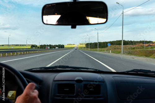 view of the road through the front window of the car