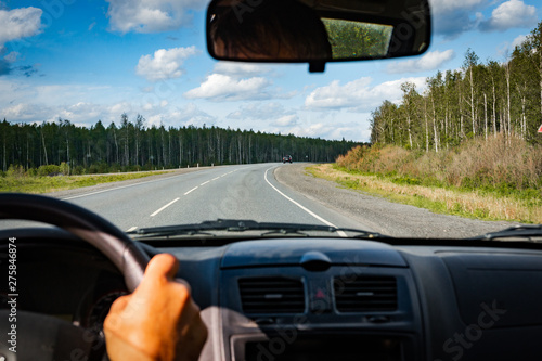 view of the road through the front window of the car