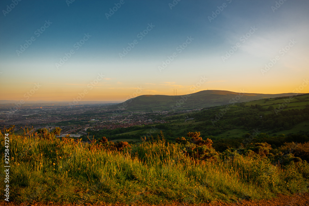 Colorful sunset at Cave Hill Country Park Belfast, Northern Ireland. Aerial view on City and hills Colorful sunset at Cave Hill Country Park Belfast, Northern Ireland. Aerial view on City and hills