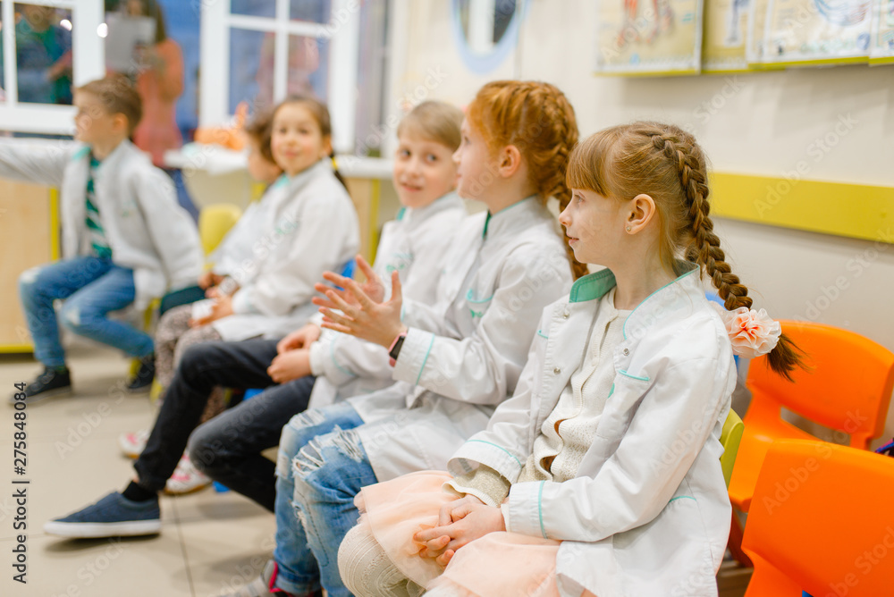 Children learning doctor profession in classroom