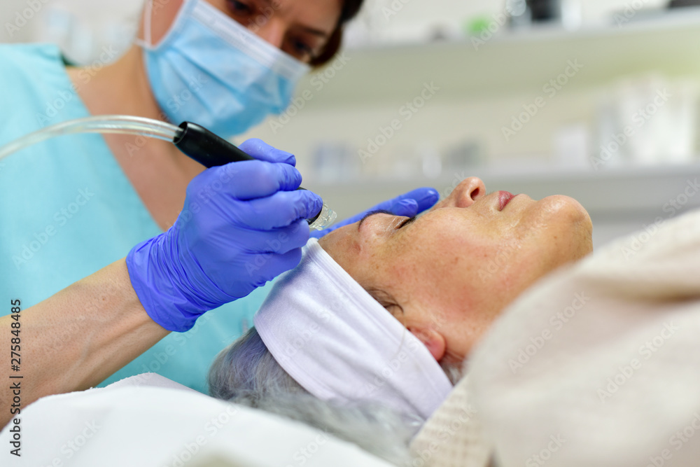 Obraz premium Skin care. Woman receiving facial beauty treatment. Facial therapy. Anti-aging procedures.