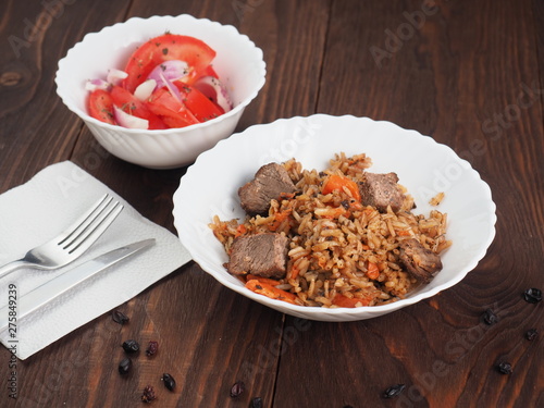 Fototapeta Naklejka Na Ścianę i Meble -  Rice with Vegetables and Meat in a plate on wooden table