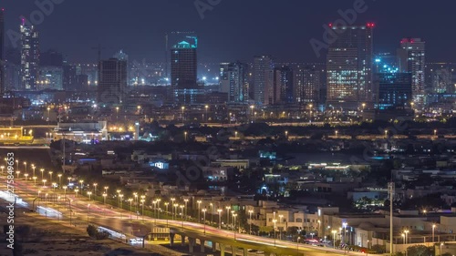 Wallpaper Mural Aerial view to houses and villas near Golf course with lakes night timelapse. Construction site in Jumeirah village circle district. Traffic on the road Torontodigital.ca