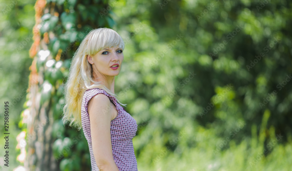 Portrait of the young beautiful girl against the background of the summer wood Portrait of the young beautiful girl against the background of the summer wood