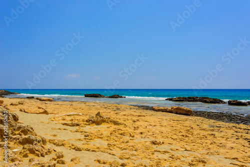 Fototapeta Naklejka Na Ścianę i Meble -   pristine seascapes with crystal clear blue water and yellow rocks in Ayia Napa, Cyprus