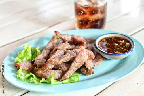 Grilled meats of Thai food in a dish with dipping sauce