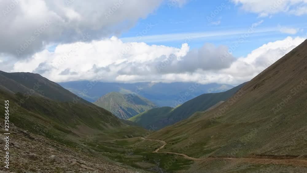 Timelapse in mountains with beautiful clouds moving fast in national park of Dombay, Caucasus, Russia. Summer landscape, sunshine weather, blue sky and sunny day Timelapse in mountains with beautiful clouds moving fast in national park of Dombay, Caucasus, Russia. Summer landscape, sunshine weather, blue sky and sunny day