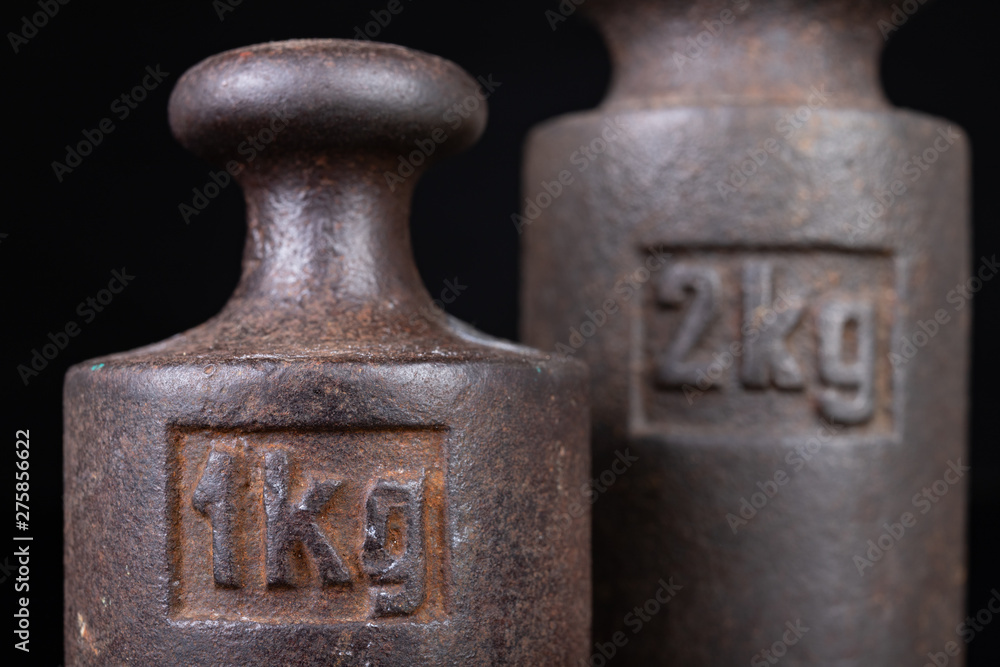 Old kilo weights on books. Old books and weighing machines. Old kilo weights on books. Old books and weighing machines.