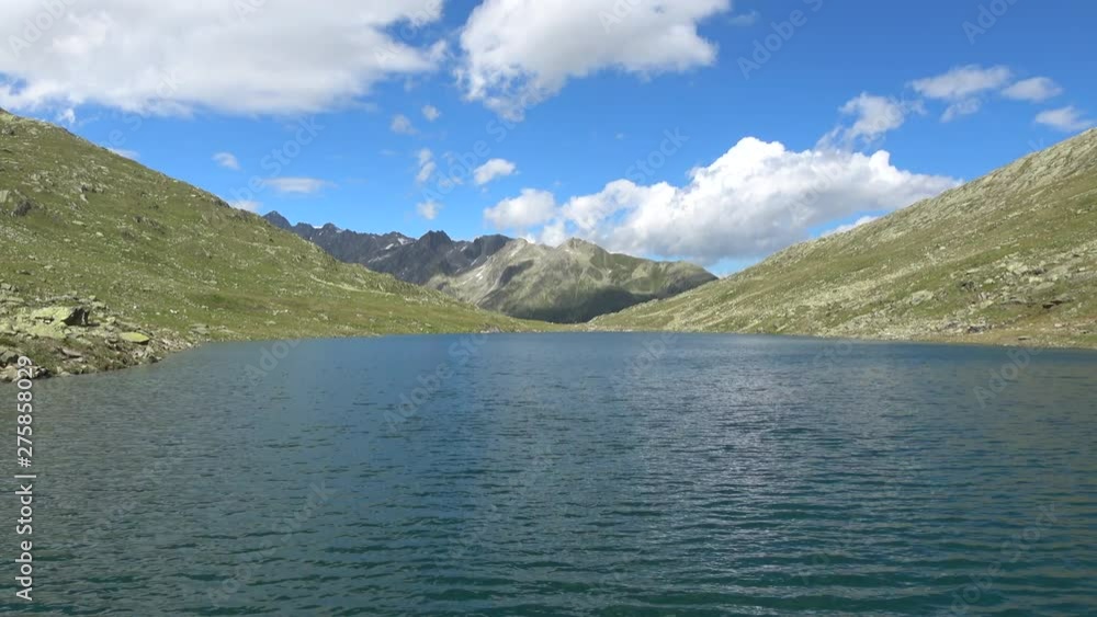 Scenic view of peak of mountains and lake in Swiss Alps. Summer landscape, sunshine weather, blue sky and sunny day Scenic view of peak of mountains and lake in Swiss Alps. Summer landscape, sunshine weather, blue sky and sunny day