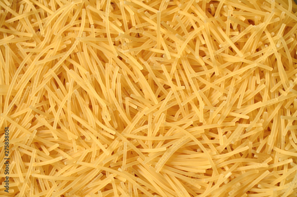 Dry uncooked vermicelli as a background texture. Close-up, top view Dry uncooked vermicelli as a background texture. Close-up, top view
