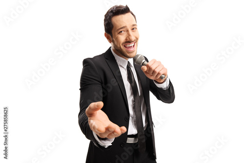 Handsome male singer in a black suit singing on a microphone