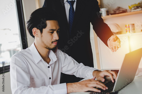 Job training. new manager boss mentor teaching online work to young intern man apprentice learning, working on laptop computer at home office, adviser, internship, practicum, business trainee concept photo