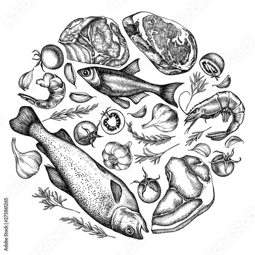 Round floral design with black and white garlic, cherry tomatoes, fish, shrimp, beef, rosemary